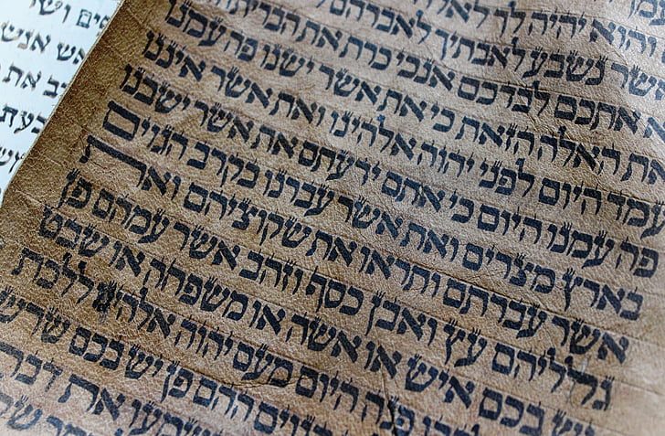 A close-up of a handwritten Torah scroll in Hebrew